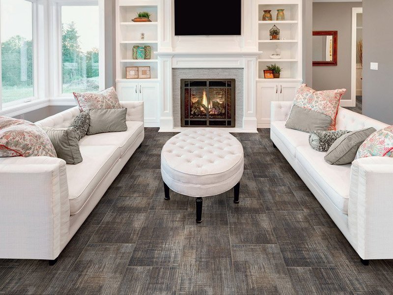 white coach, fireplace on white wall and brown hardwood - Heath Flooring Concept in Dallas, GA